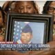 family holding framed picture of their son in an air force uniform